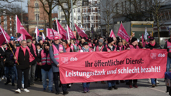 Der Demonstrationszug mit pinken Bannern auf einer Straße in Hamburg